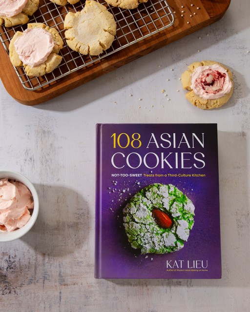 Photo of the book 108 Asian Cookies next to sugar cookies with pink frosting